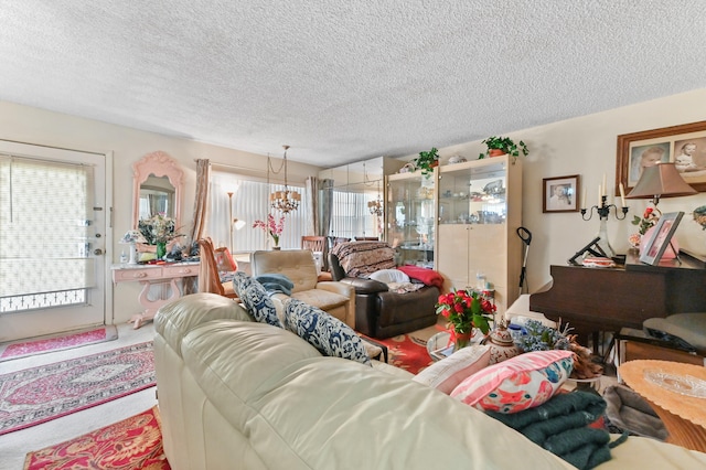 carpeted living room featuring a chandelier and a textured ceiling