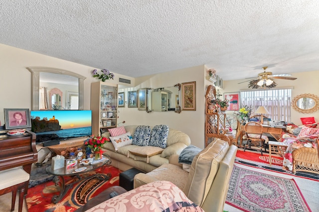 living room featuring ceiling fan and a textured ceiling