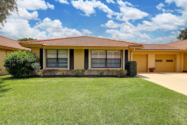 view of front of property featuring a garage and a front lawn