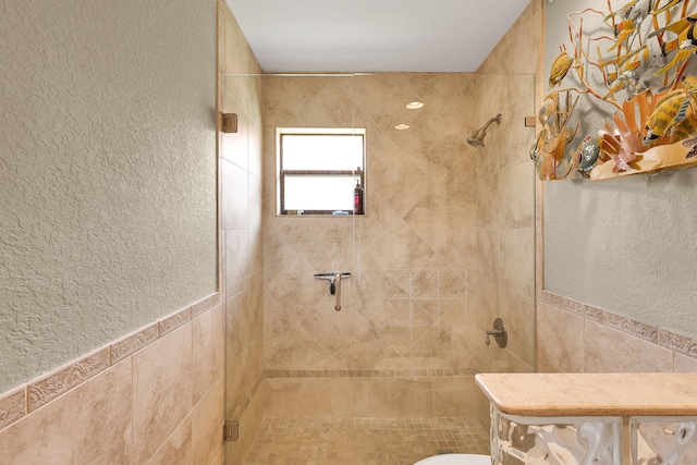 bathroom with toilet, an enclosed shower, and tile walls