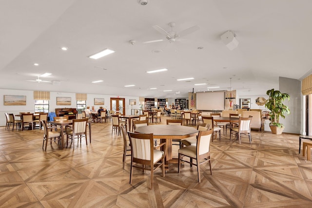 dining space featuring light parquet flooring and ceiling fan