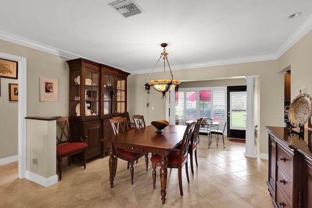 dining area with light tile patterned flooring, ornate columns, and ornamental molding