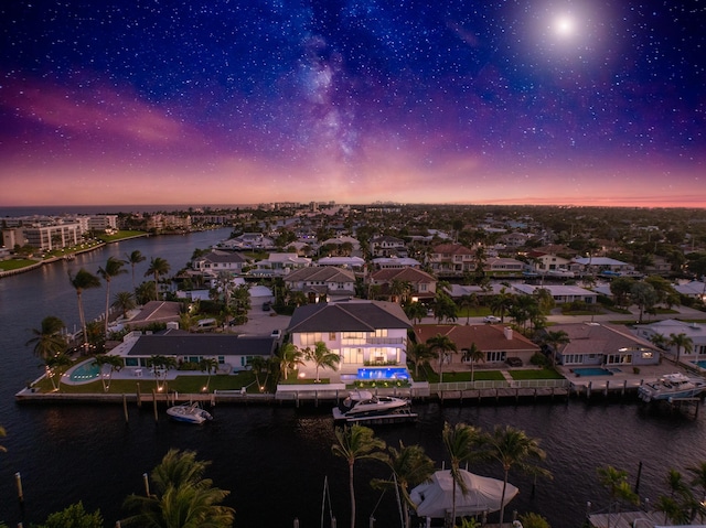 aerial view at dusk with a water view