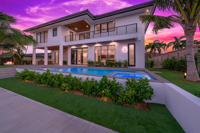 view of pool featuring a fenced in pool, an in ground hot tub, fence, a yard, and a patio area