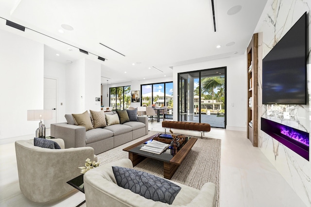 living area featuring a high end fireplace and recessed lighting