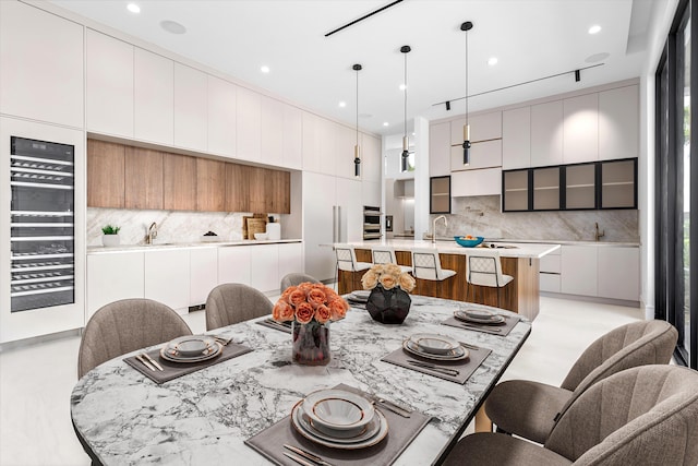 dining room featuring wine cooler and recessed lighting