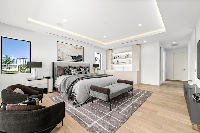 bedroom featuring recessed lighting, a raised ceiling, visible vents, and light wood-style floors