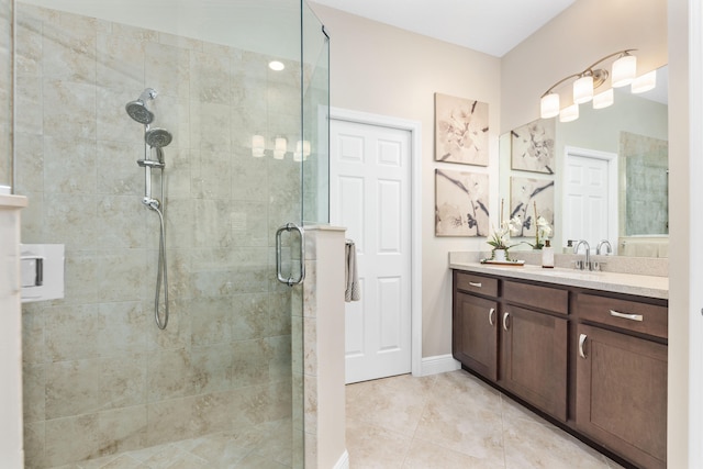 bathroom featuring tile patterned flooring, vanity, and a shower with shower door