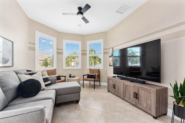 tiled living room with ceiling fan