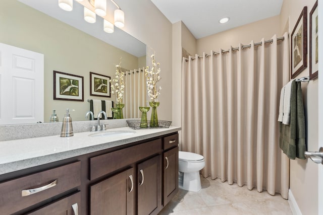 bathroom featuring tile patterned floors, vanity, and toilet