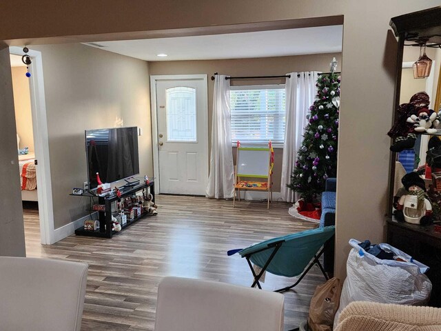 bedroom with hardwood / wood-style floors and multiple windows