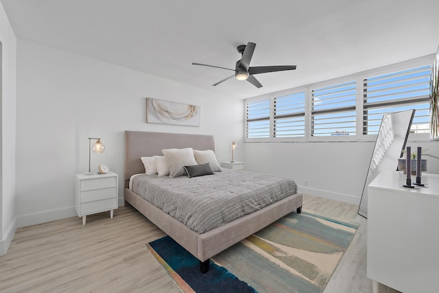 bedroom with light hardwood / wood-style floors and ceiling fan