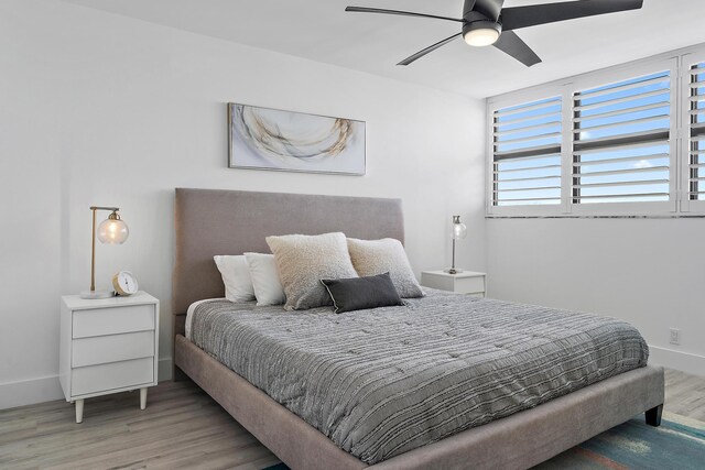 bedroom with hardwood / wood-style flooring and ceiling fan