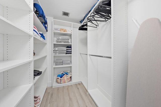 spacious closet with light hardwood / wood-style flooring