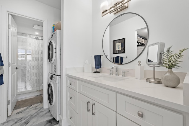 bathroom with vanity and stacked washer / dryer