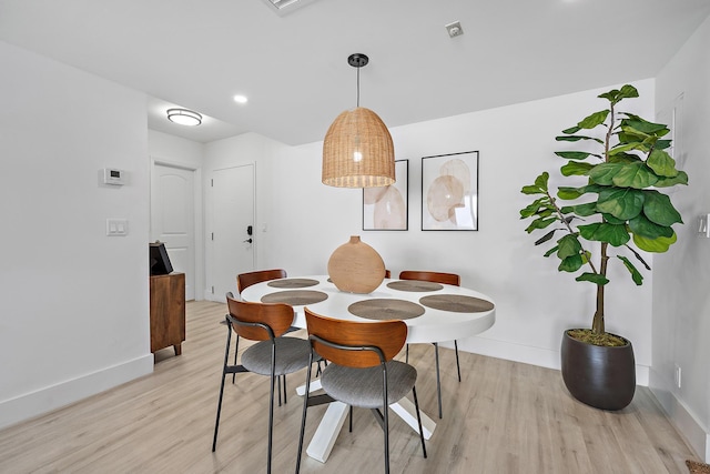 dining space with light hardwood / wood-style floors