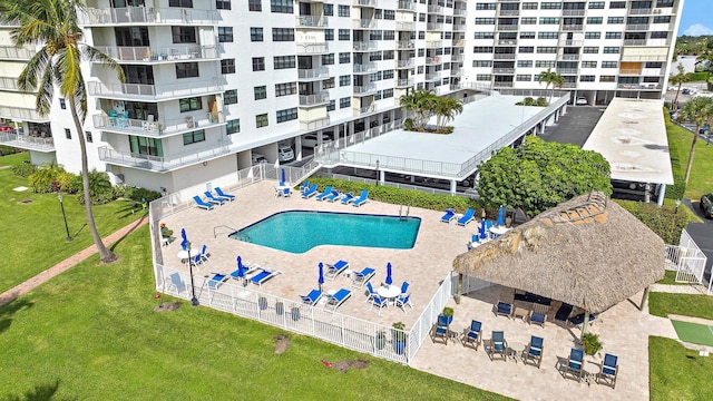 view of pool featuring a lawn and a patio area