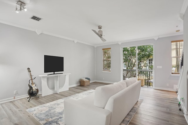 living room with ceiling fan, crown molding, and light wood-type flooring