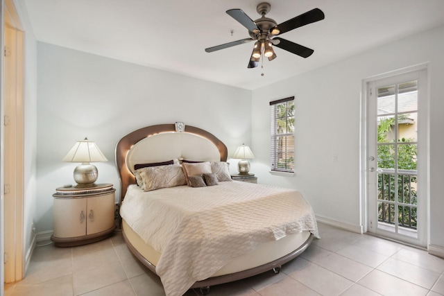 tiled bedroom with multiple windows, access to outside, and ceiling fan