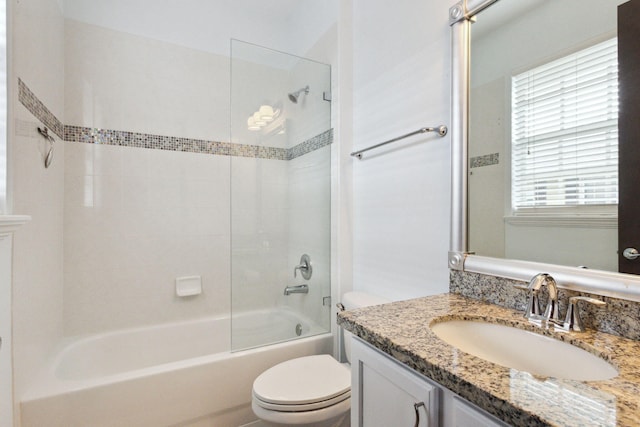 full bathroom with vanity, toilet, and tiled shower / bath combo