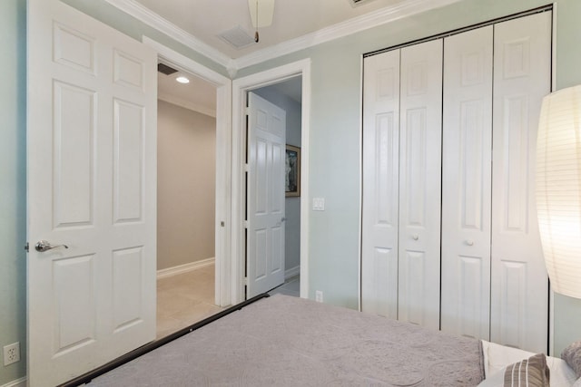 unfurnished bedroom featuring crown molding, a closet, ceiling fan, and light tile patterned floors