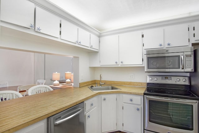 kitchen featuring white cabinets, sink, and stainless steel appliances