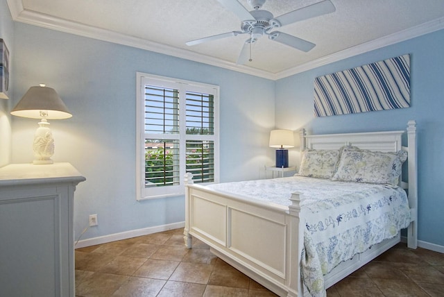 bedroom featuring ceiling fan, dark tile patterned floors, ornamental molding, and a textured ceiling