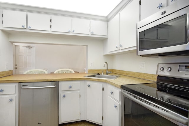 kitchen featuring sink, white cabinets, and stainless steel appliances