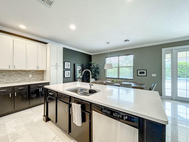 kitchen with stainless steel dishwasher, white cabinets, plenty of natural light, and sink