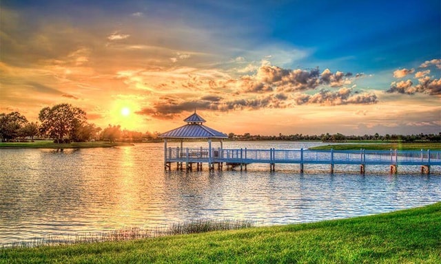 view of dock with a gazebo and a water view