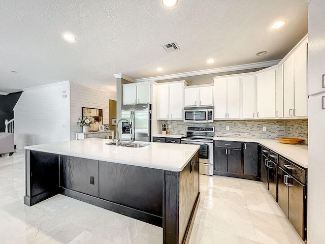 kitchen with white cabinetry, sink, an island with sink, and stainless steel appliances