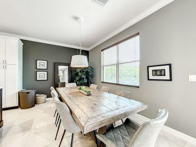 dining area featuring light tile patterned floors and crown molding