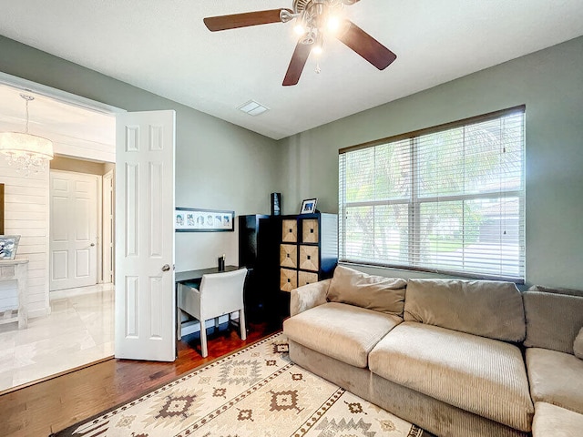 living room featuring hardwood / wood-style flooring and ceiling fan