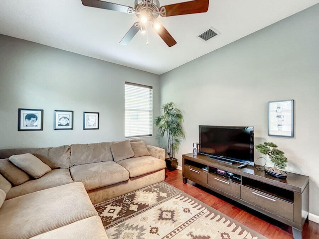 living room featuring wood-type flooring, ceiling fan, and lofted ceiling