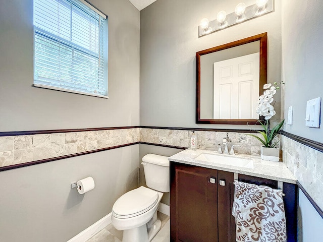 bathroom featuring vanity, tile patterned floors, and toilet