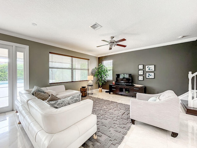 tiled living room featuring a wealth of natural light, a textured ceiling, and ceiling fan