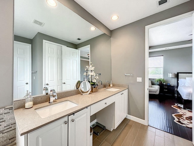 bathroom featuring vanity and wood-type flooring