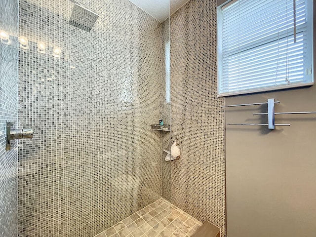 bathroom with a tile shower