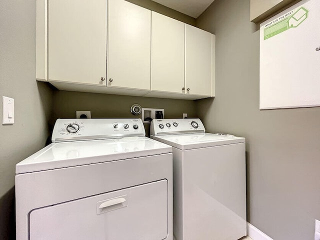 laundry area featuring cabinets and washing machine and clothes dryer