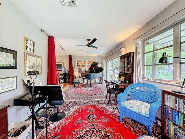 sitting room with ceiling fan and a wealth of natural light