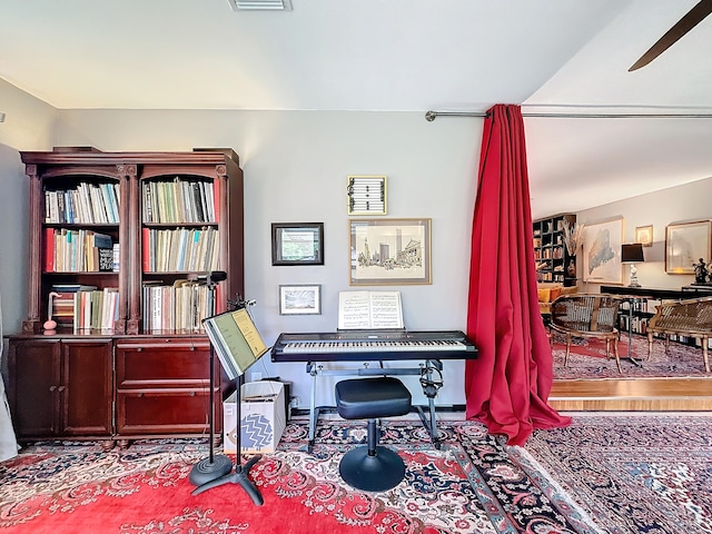 misc room with light wood-type flooring and ceiling fan