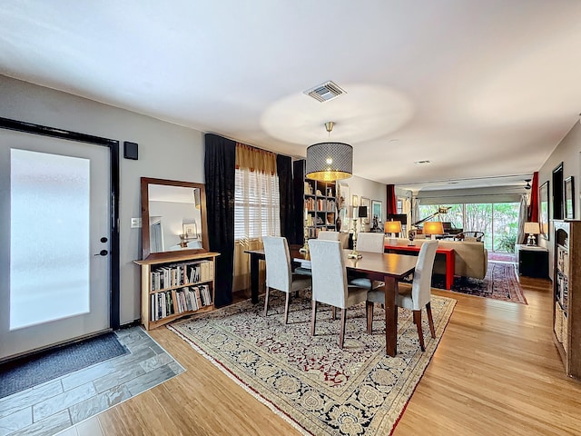 dining space with hardwood / wood-style flooring