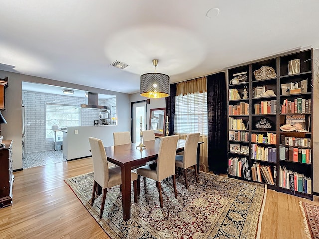 dining space with light hardwood / wood-style flooring