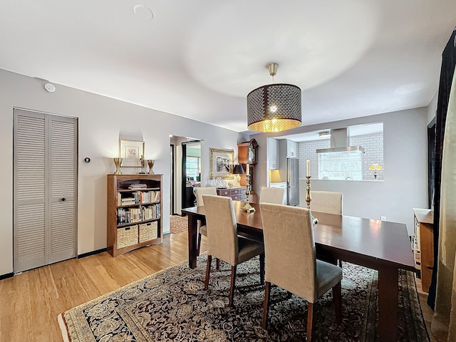 dining space with light wood-type flooring