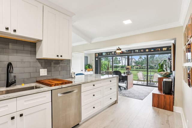 kitchen featuring dishwasher, sink, white cabinetry, and decorative backsplash