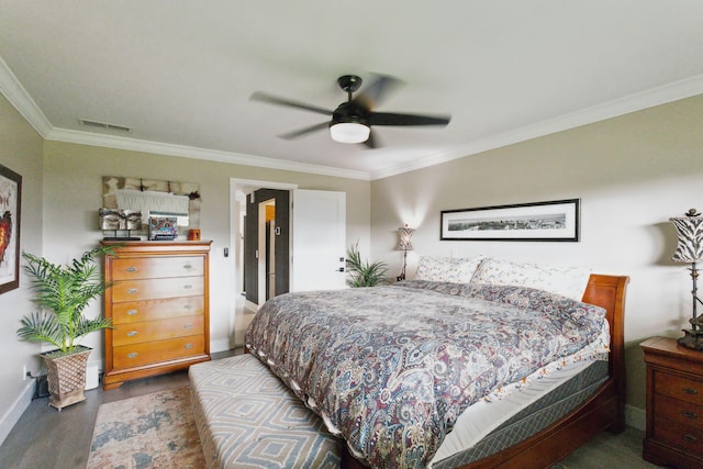 bedroom featuring visible vents, ornamental molding, a ceiling fan, wood finished floors, and baseboards