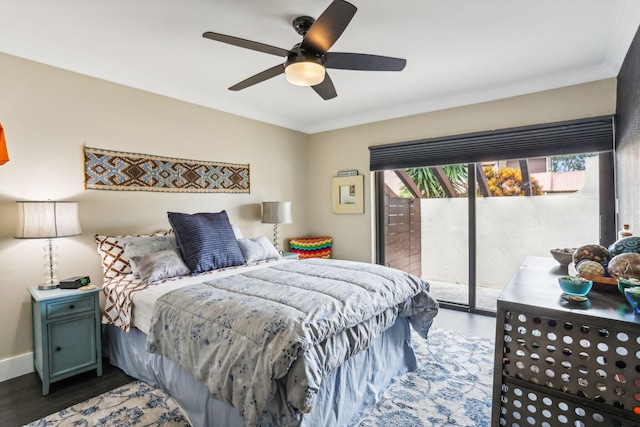 bedroom featuring a ceiling fan, wood finished floors, crown molding, baseboards, and access to exterior