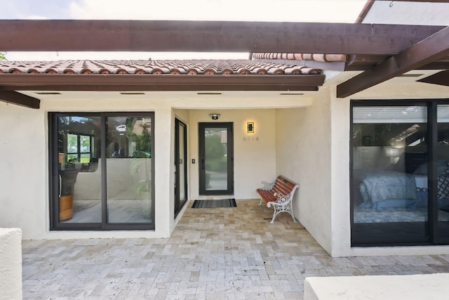 entrance to property featuring a patio