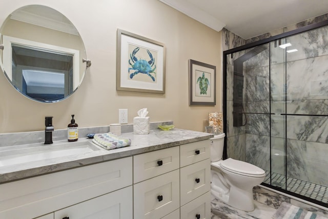 bathroom with toilet, vanity, a shower with door, and crown molding