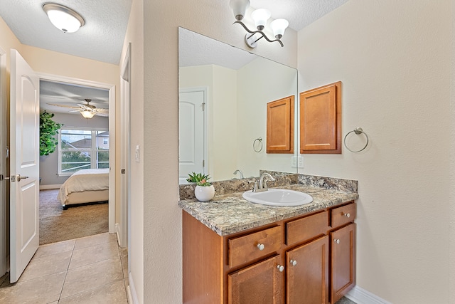 bathroom with vanity, ceiling fan, tile patterned flooring, and a textured ceiling